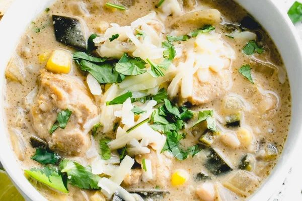 Mexican chicken soup in a bowl with tortilla chips.