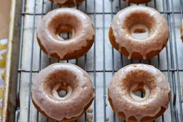 Glazed donuts on a cooling rack.
