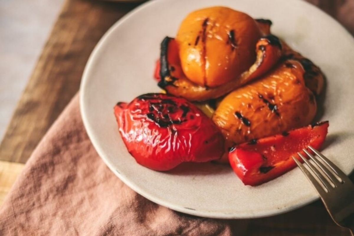 Grilled peppers on a plate with a fork and Thanksgiving.