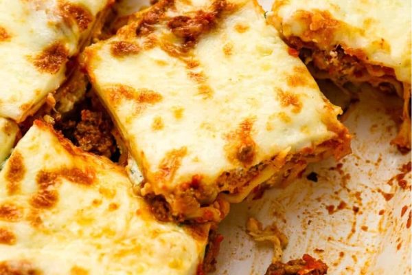 Lasagna with meat and cheese on a white plate.
