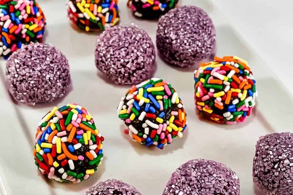 A white plate with purple sprinkles on it.