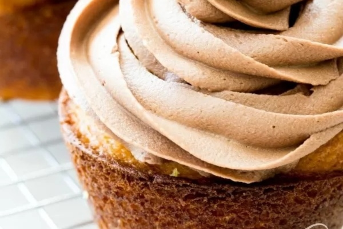 Nutella cupcakes with chocolate frosting on a cooling rack.