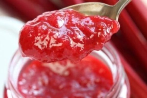 Rhubarb jam recipe in a jar with a spoon.