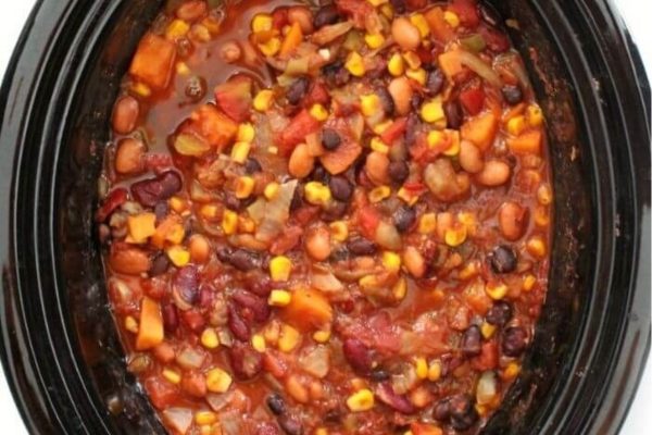 A bowl of food with red sauce.