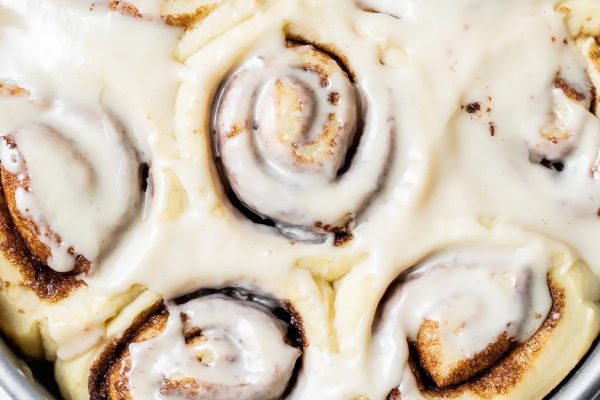 Cinnamon rolls with icing baked in a pan.