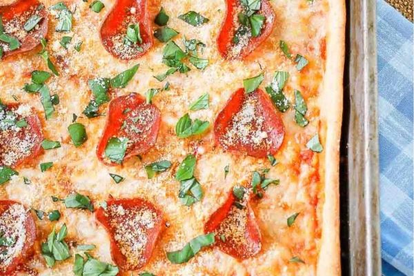 A budget-friendly pepperoni pizza on a baking sheet.