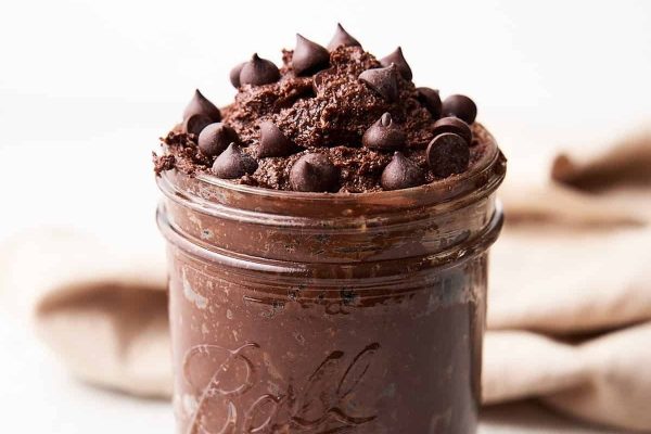 A mason jar filled with chocolate chips, perfect for brownie recipes.