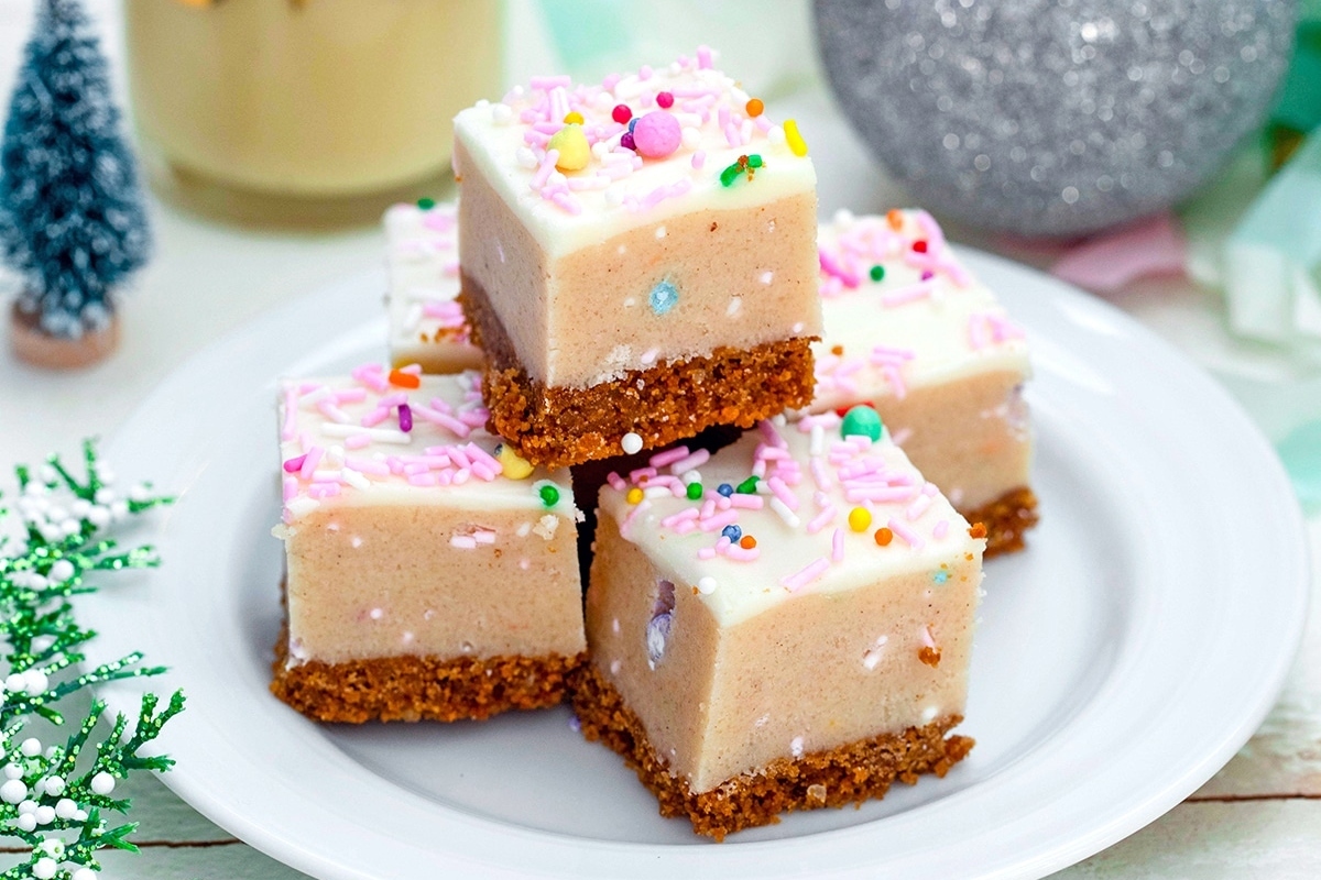 Five squares of fudge stacked on a plate, perfect for indulging in delicious homemade treats during the holiday season.