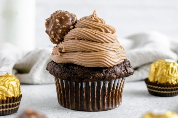 A festive Christmas cupcake adorned with rich chocolate frosting and Ferrero Rocher.