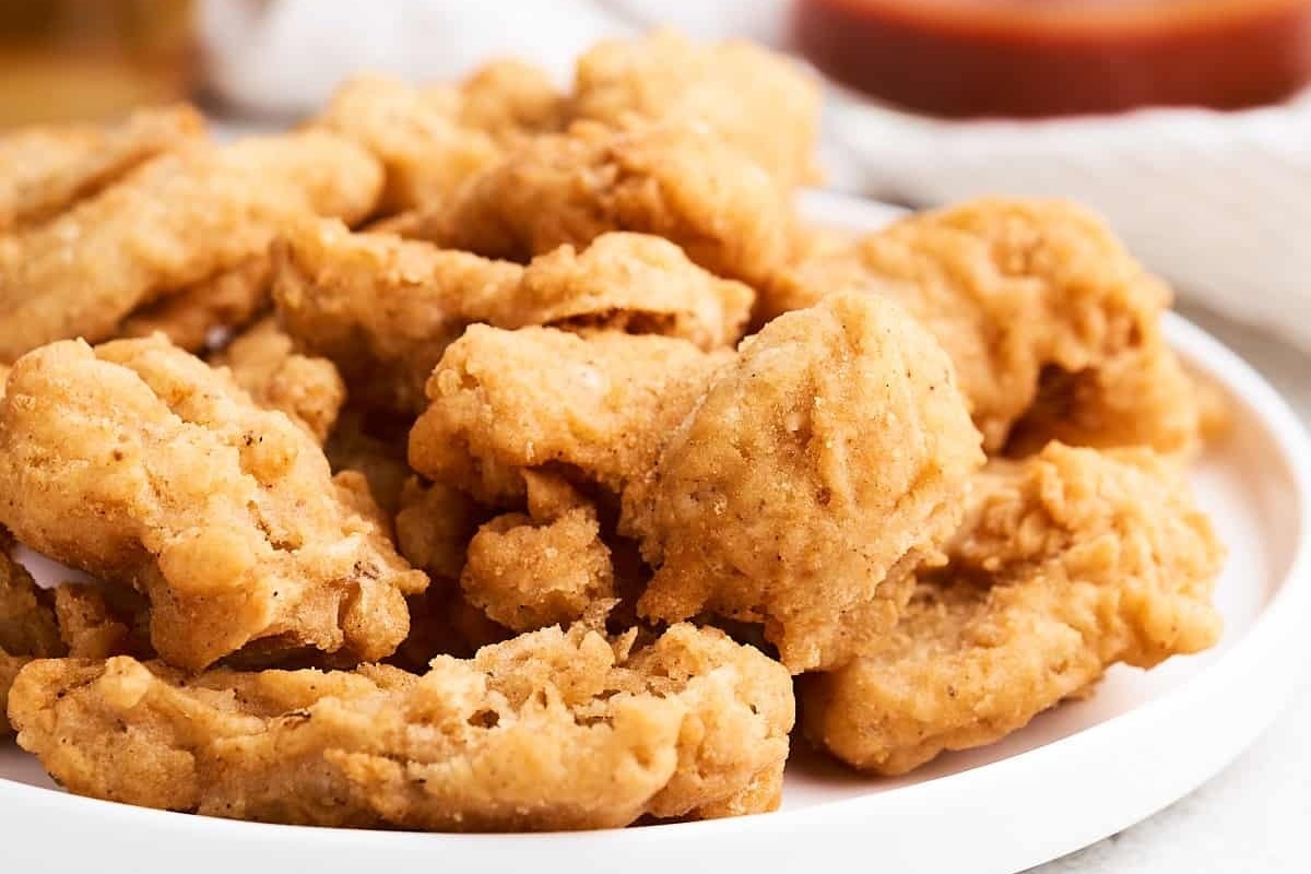 Mushroom-filled fried chicken nuggets on a white plate.