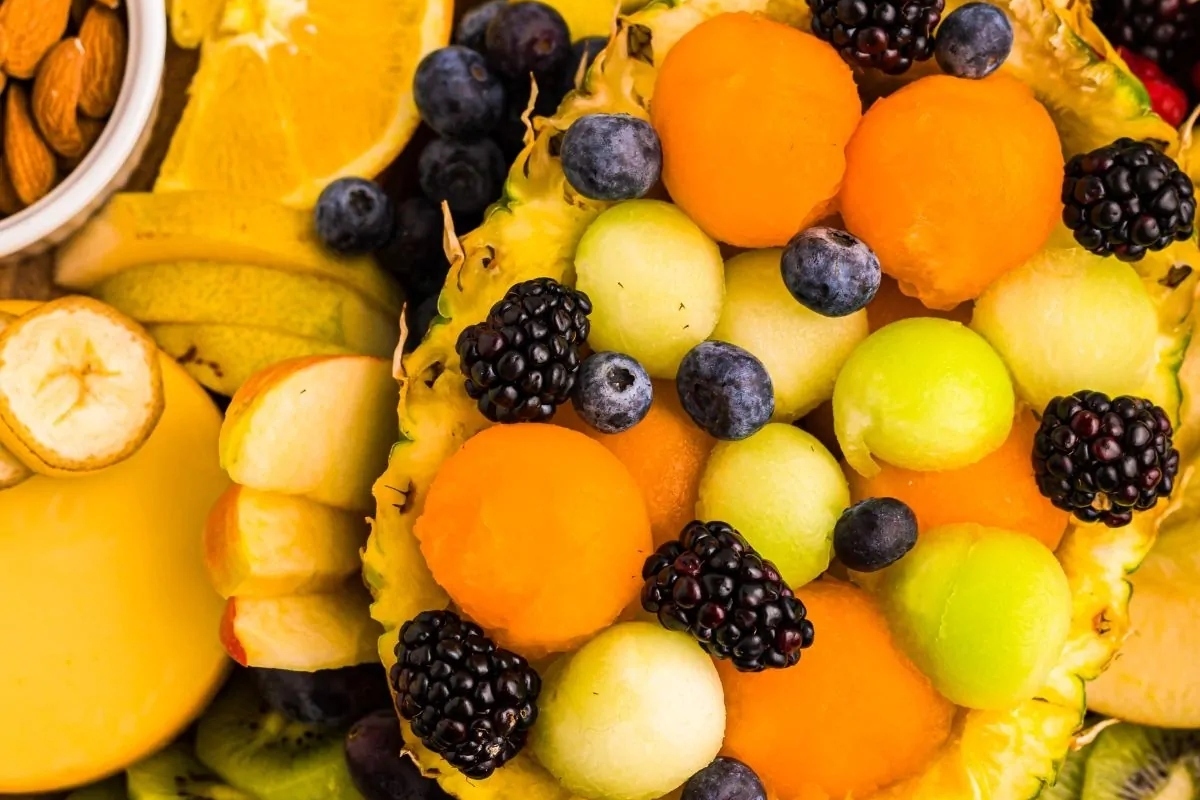 A variety of fruits and nuts are arranged in a bowl, perfect for New Year's Eve appetizers.