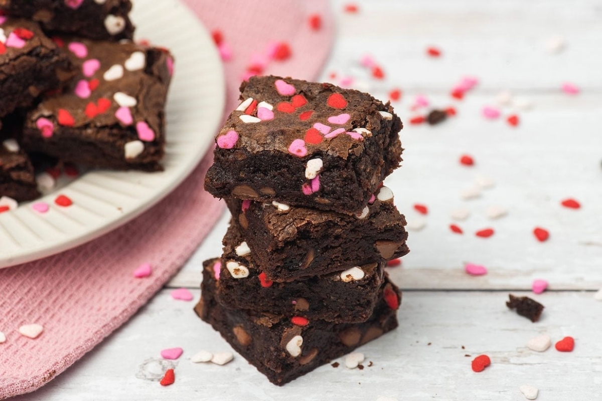 A stack of brownies with sprinkles on top, made with a delicious brownie recipe.