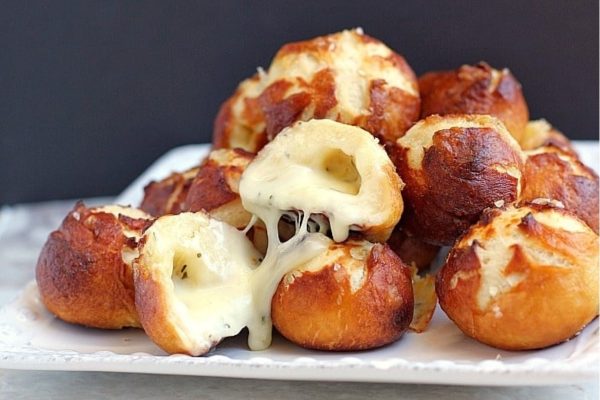 Cheesy bread balls on a white plate.