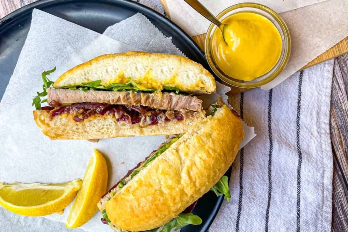 A sandwich with mustard and lemon, served on a bun.