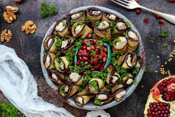 Stuffed eggplants with nuts and pomegranate on a plate.