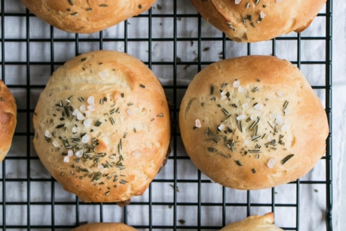 Sourdough rosemary rolls in a bread basket.