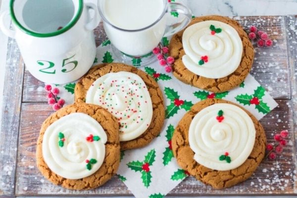 Gingerbread cookies with icing and holly leaves.