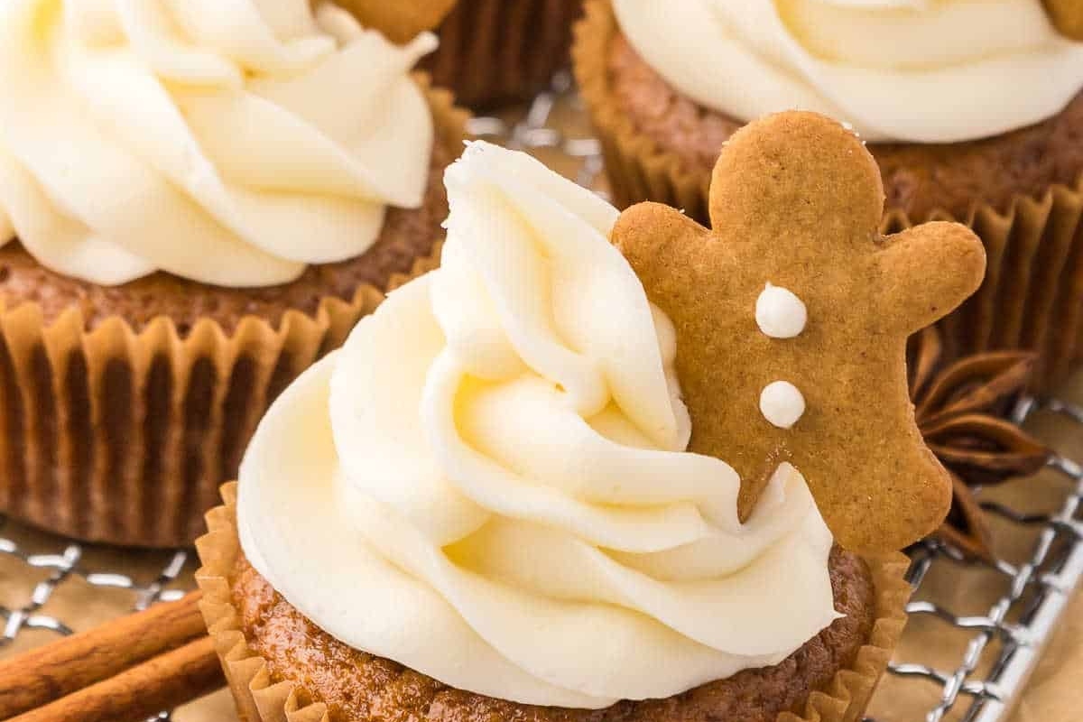 Cute Christmas gingerbread cupcakes with icing and cinnamon sticks.
