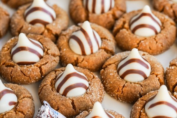 A plate of cookies decorated with chocolate and white icing.