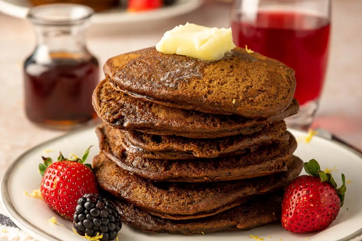 Pancakes with strawberries on the side.