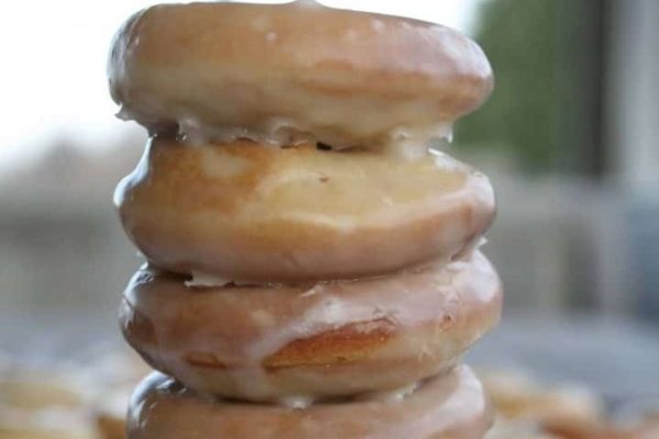 A stack of donuts with frosting.