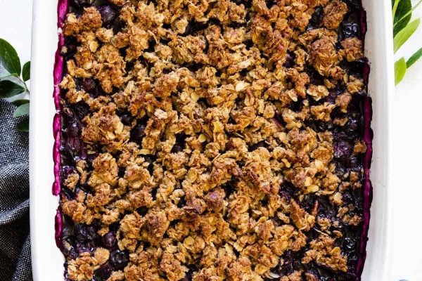 Blueberry crumble in a white baking dish.