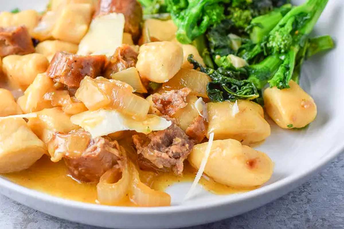 Delicious Gnocchi recipe with meat and broccoli served in a white bowl.