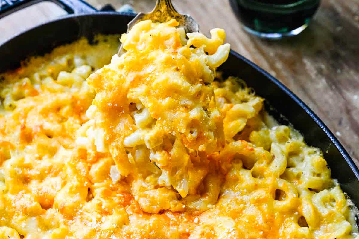 Cheesy macaroni and cheese, a classic pub favorite, cooked in a skillet.