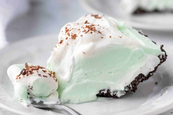 A slice of mint chocolate chip pie on a plate.