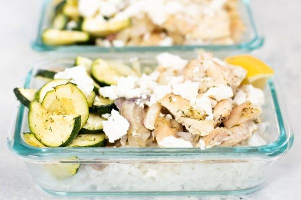 Two glass containers filled with rice and cucumbers.