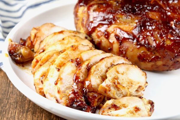 Bone-In Chicken Breast Slice with Sauce Recipe on a Plate.
