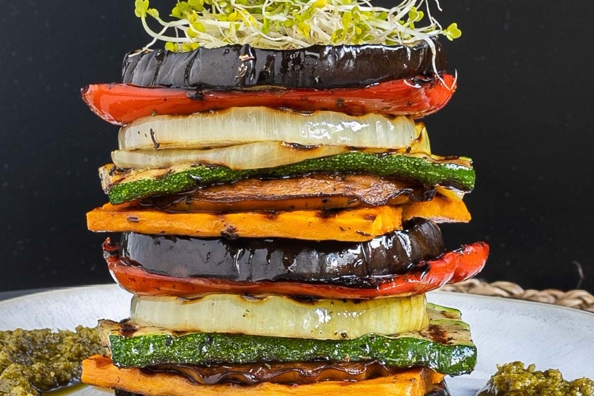 An Italian side dish consisting of a stack of grilled vegetables on a plate.
