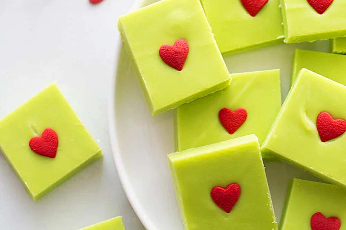 Valentine's day fudge with red hearts on a white plate.