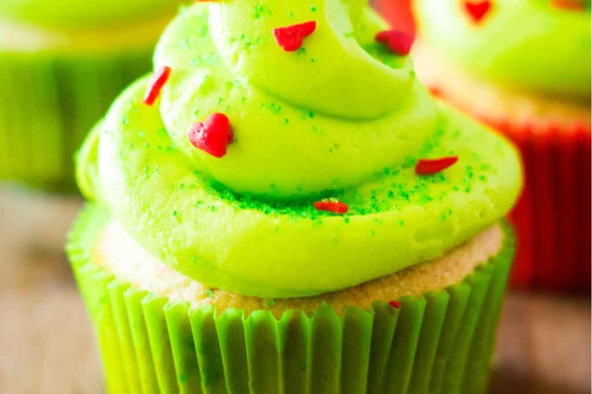 Christmas cupcakes with festive green frosting and a sprinkling of red for a delightful holiday treat.