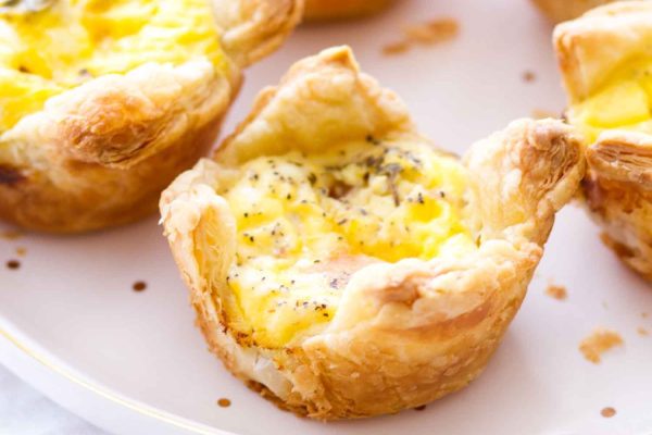 Mini quiche cups on a plate.