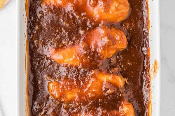 Bbq chicken in a white baking dish.