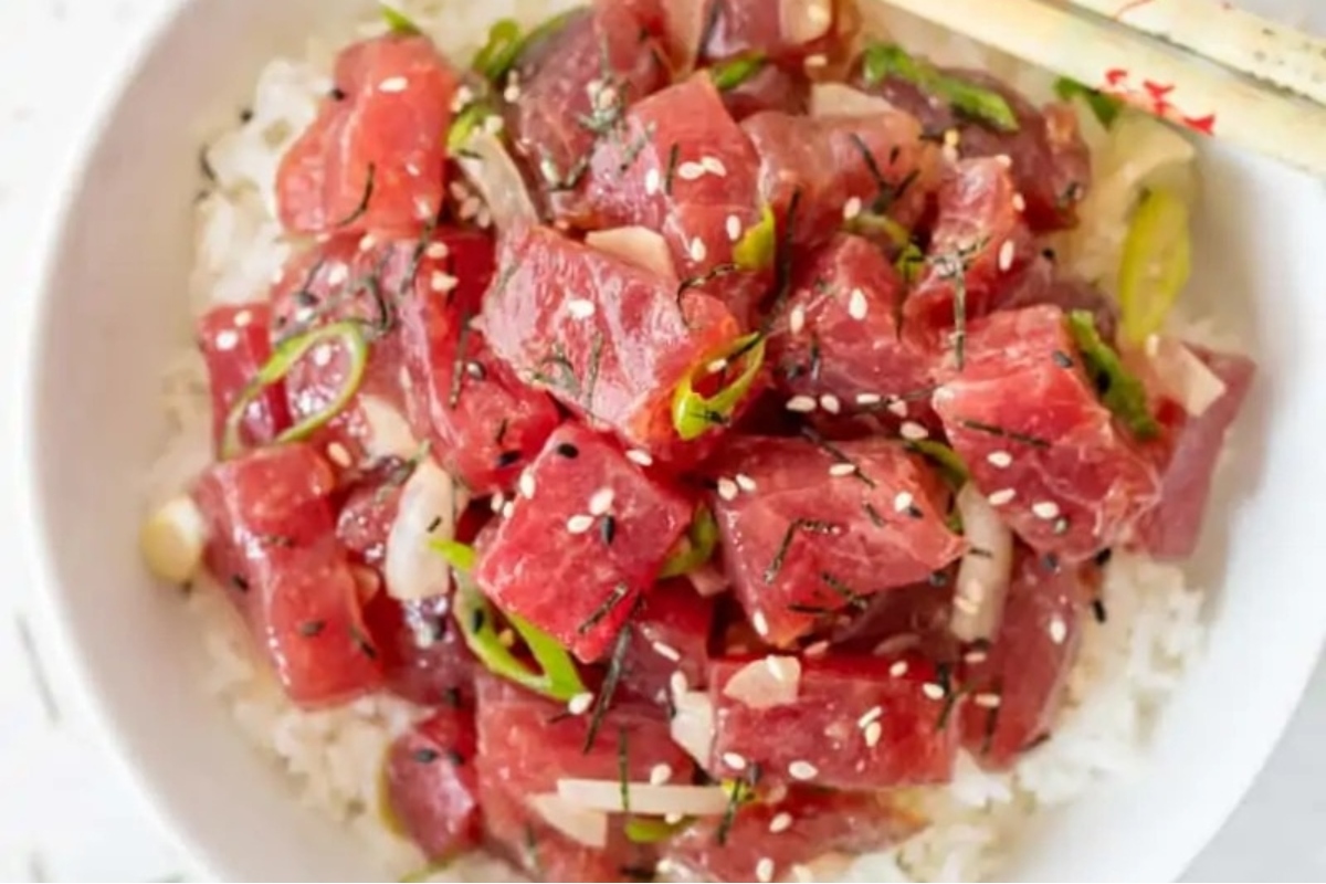 A luau-inspired bowl of tuna and rice with chopsticks.