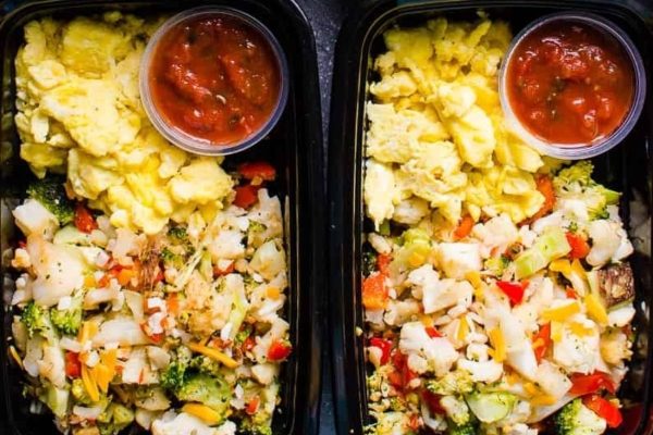 Two black plastic containers with food in them.