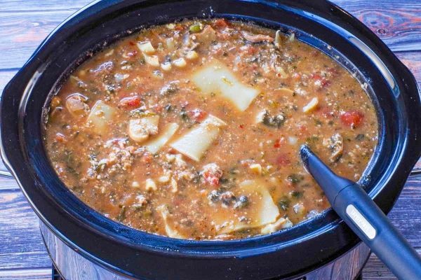 A bowl of soup with a spoon.
