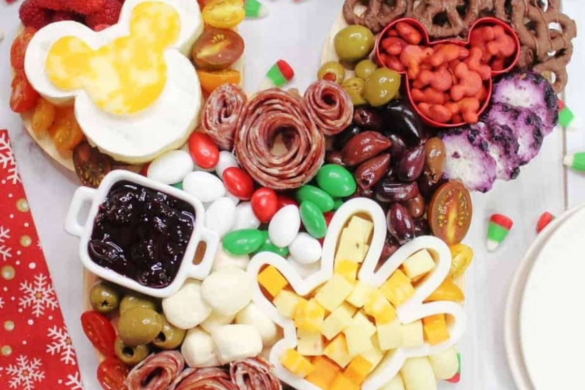 A Christmas charcuterie board adorned with a festive assortment of cheese, crackers, and other snacks.