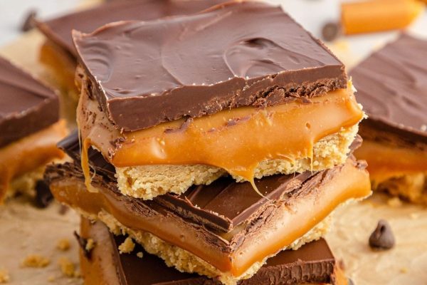 A stack of chocolate caramel bars on top of each other.