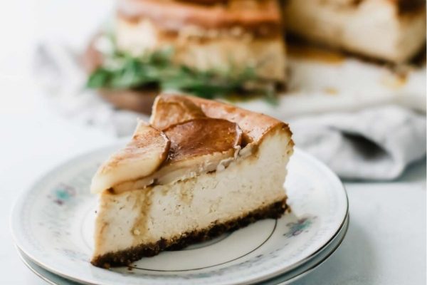 A slice of apple cheesecake on a plate.
