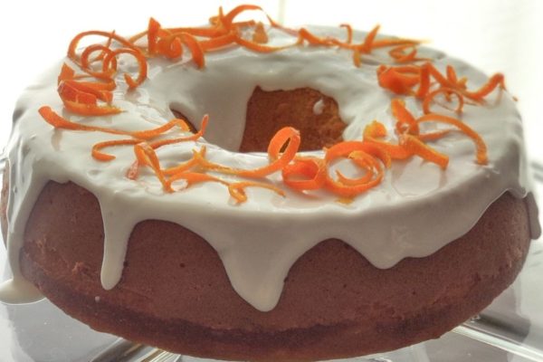 A bundt cake with orange icing on top, perfect for those looking for unique orange recipes.