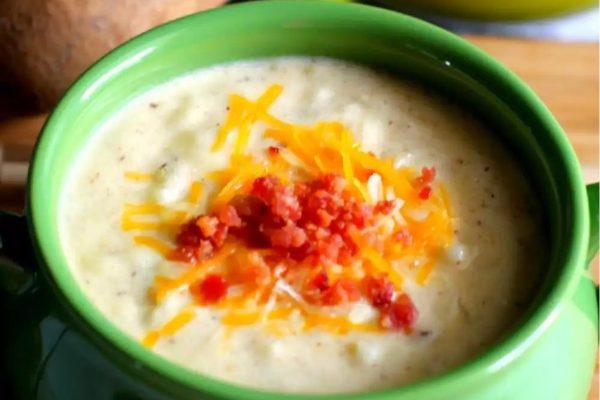A delicious cheesy soup made with just a few ingredients, served in a green bowl.