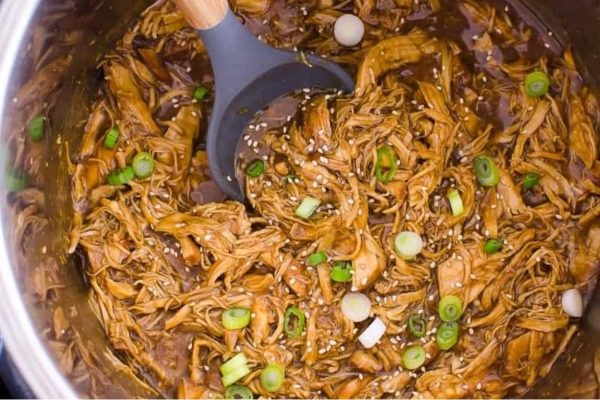 Parents will love this kid-friendly recipe of asian pulled pork, lovingly prepared and served with a wooden spoon.