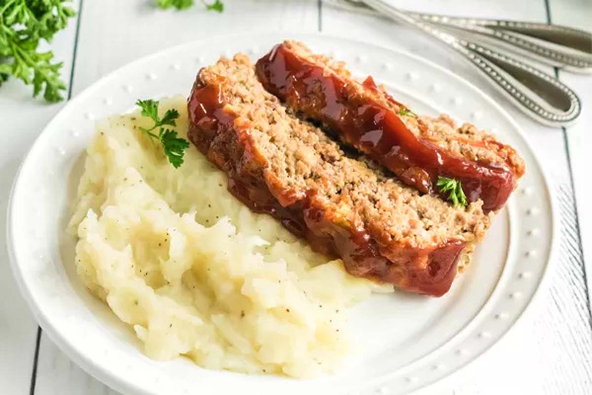 A mouthwatering plate with a delicious meatloaf and creamy mashed potatoes.