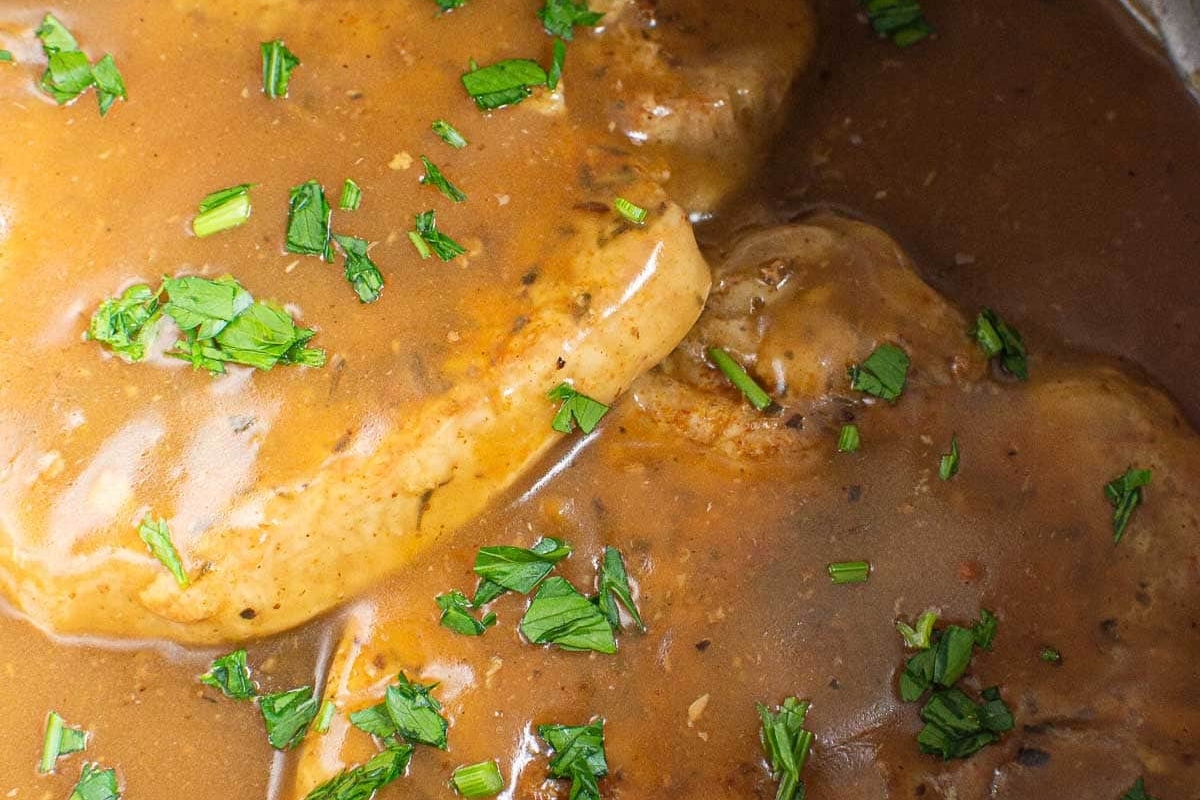Delicious pork chops in savory gravy with a touch of parsley. Perfect for dinner tonight.