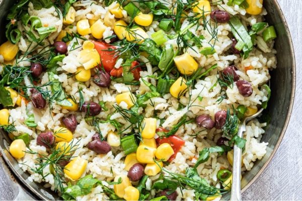 A pan filled with rice and vegetables.