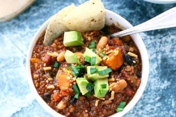 Leftover turkey chili served in a bowl with tortilla chips and avocado.