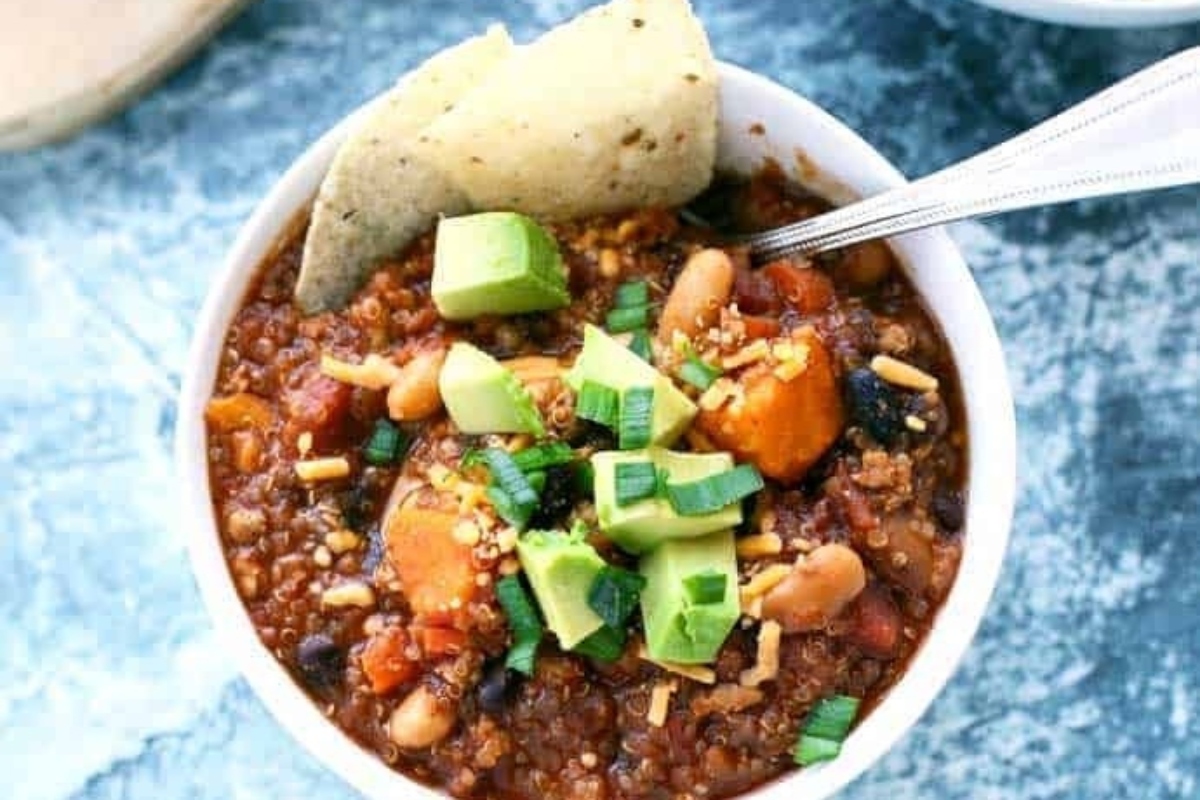 Leftover turkey chili served in a bowl with tortilla chips and avocado.